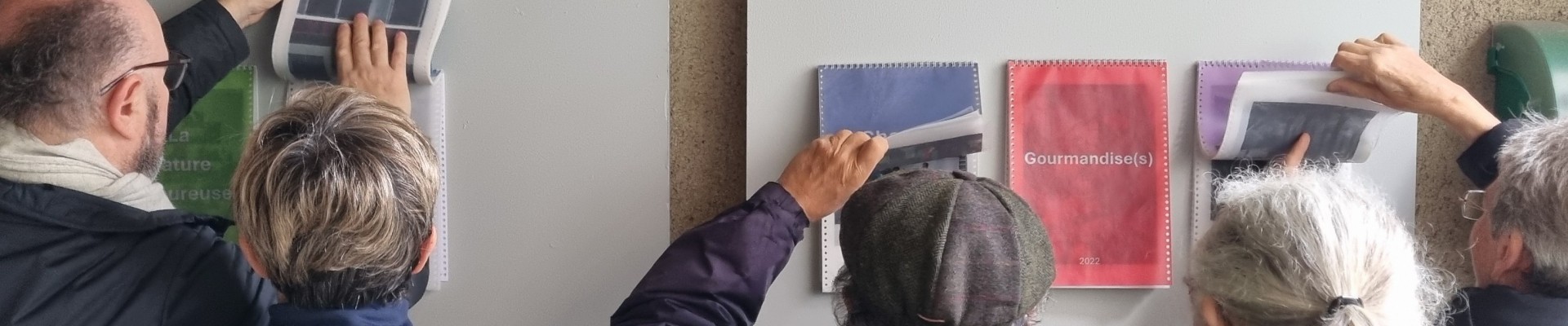 Visiteurs au vernissage de l'exposition "Cycle(s)" des adultes de l'atelier de l'imaginaire recadrant les oeuvres