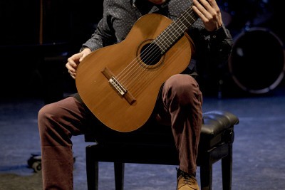 Homme assis qui joue de la guitare classique - Enlarge image 36 of 40, modal window